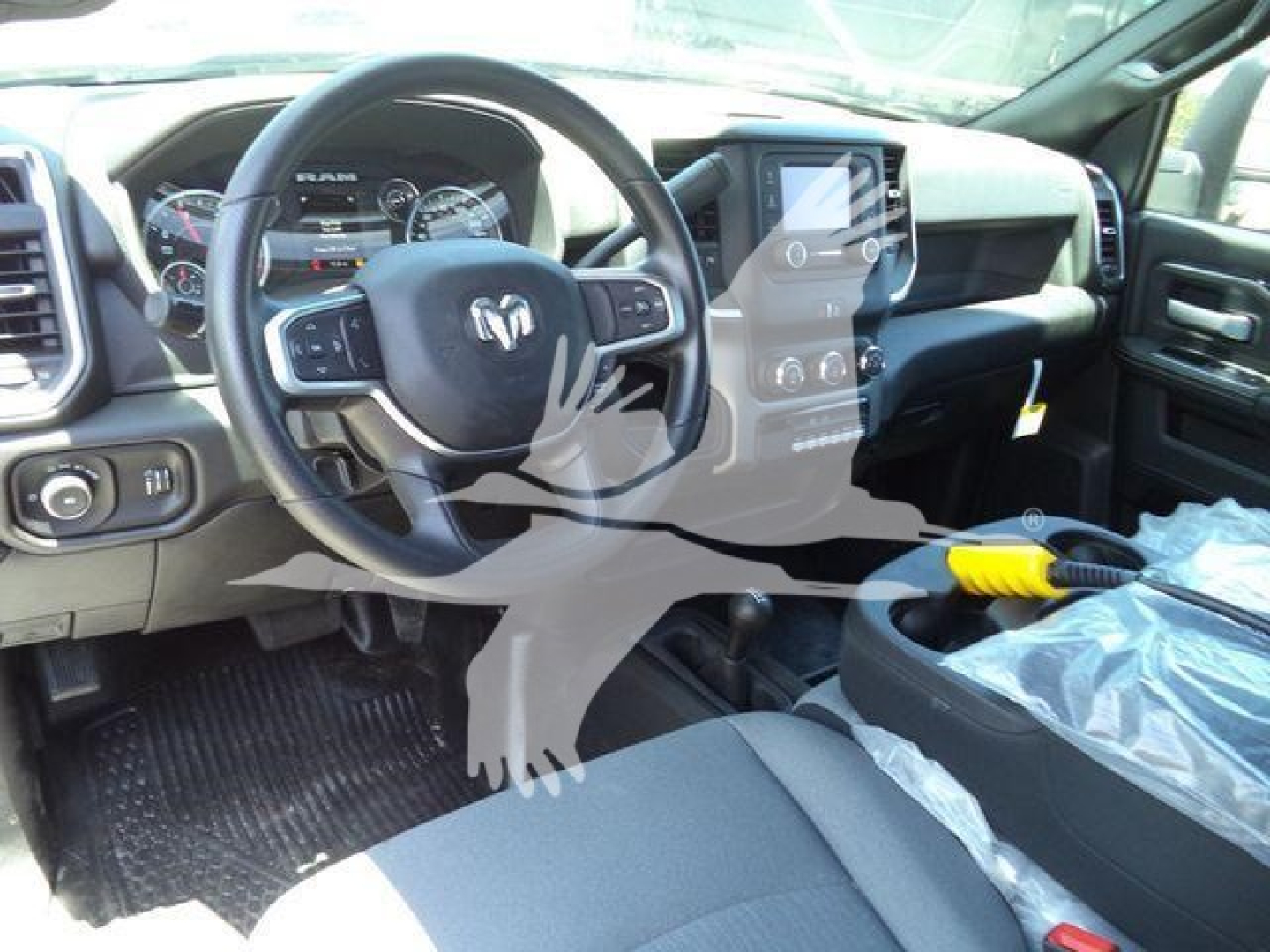 Ram 4500 interior showing steering wheel and dashboard with center touchscreen and controls.