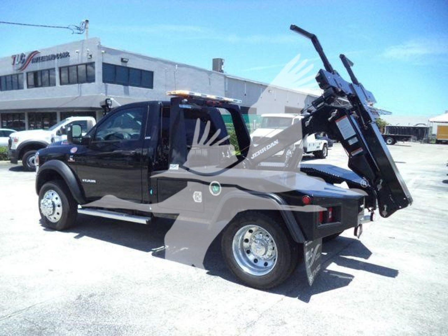Ram 4500 SLT tow truck with mounted winch and hoist in service body, side view showing rear winch arm and truck bed.