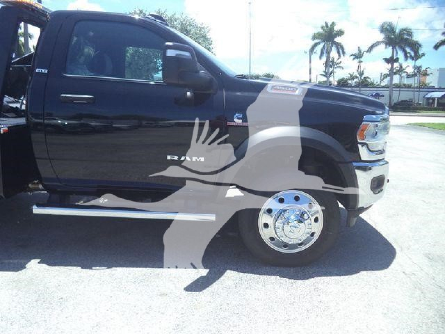Ram 4500 truck side view showing SLT badge and chrome step rails.