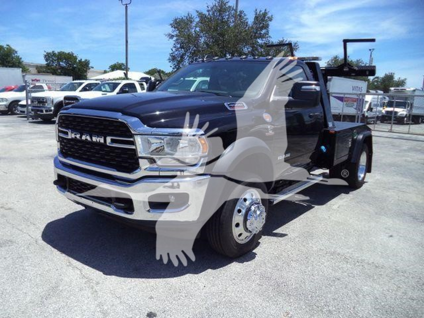 Ram 4500 SLT truck with heavy-duty tow bed and front grille, stock number J98322FM, new unit in a dealership lot.
