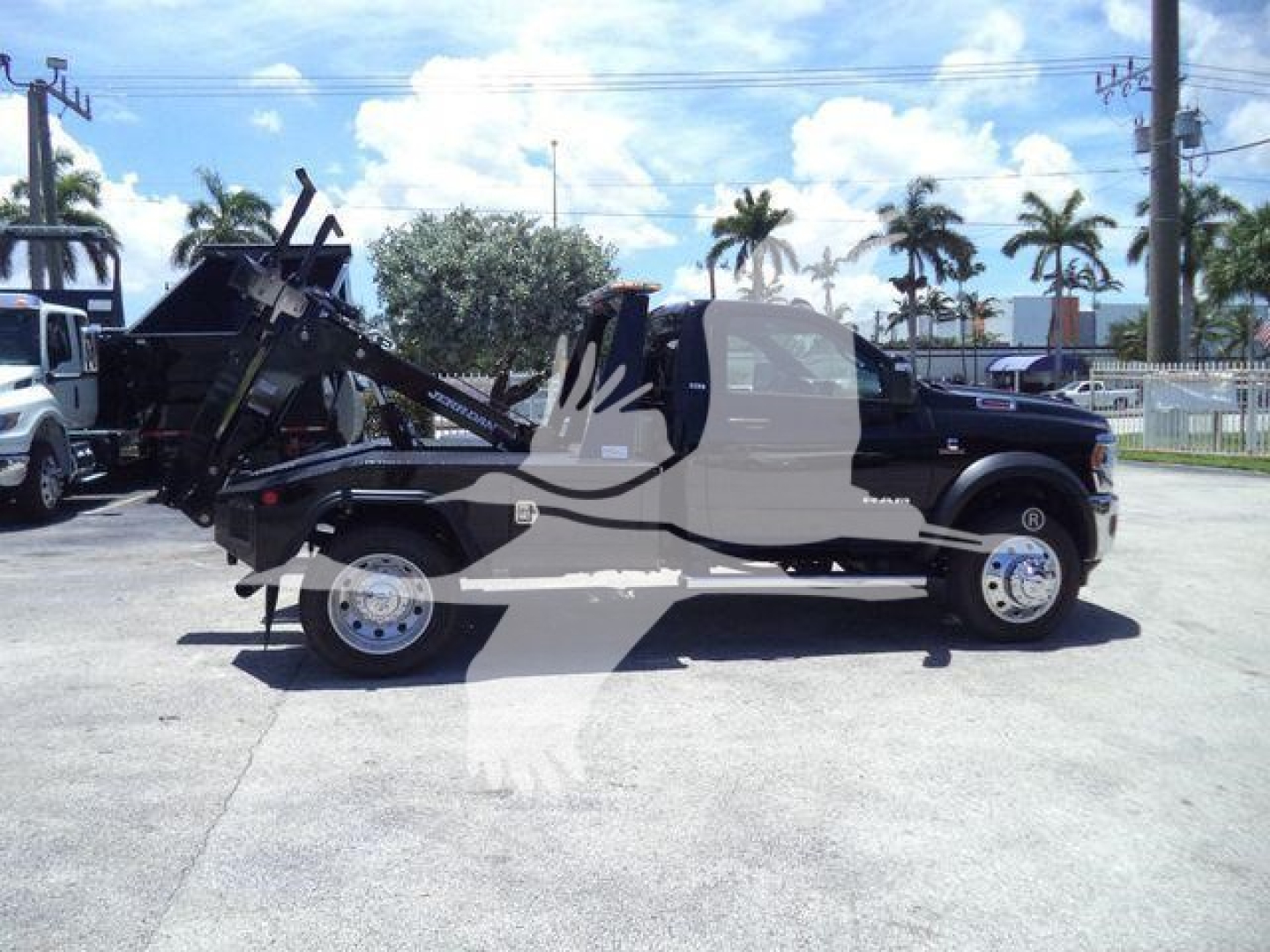 Ram 4500 SLT truck with winch in service bay showing side profile and lifted winch mechanism.