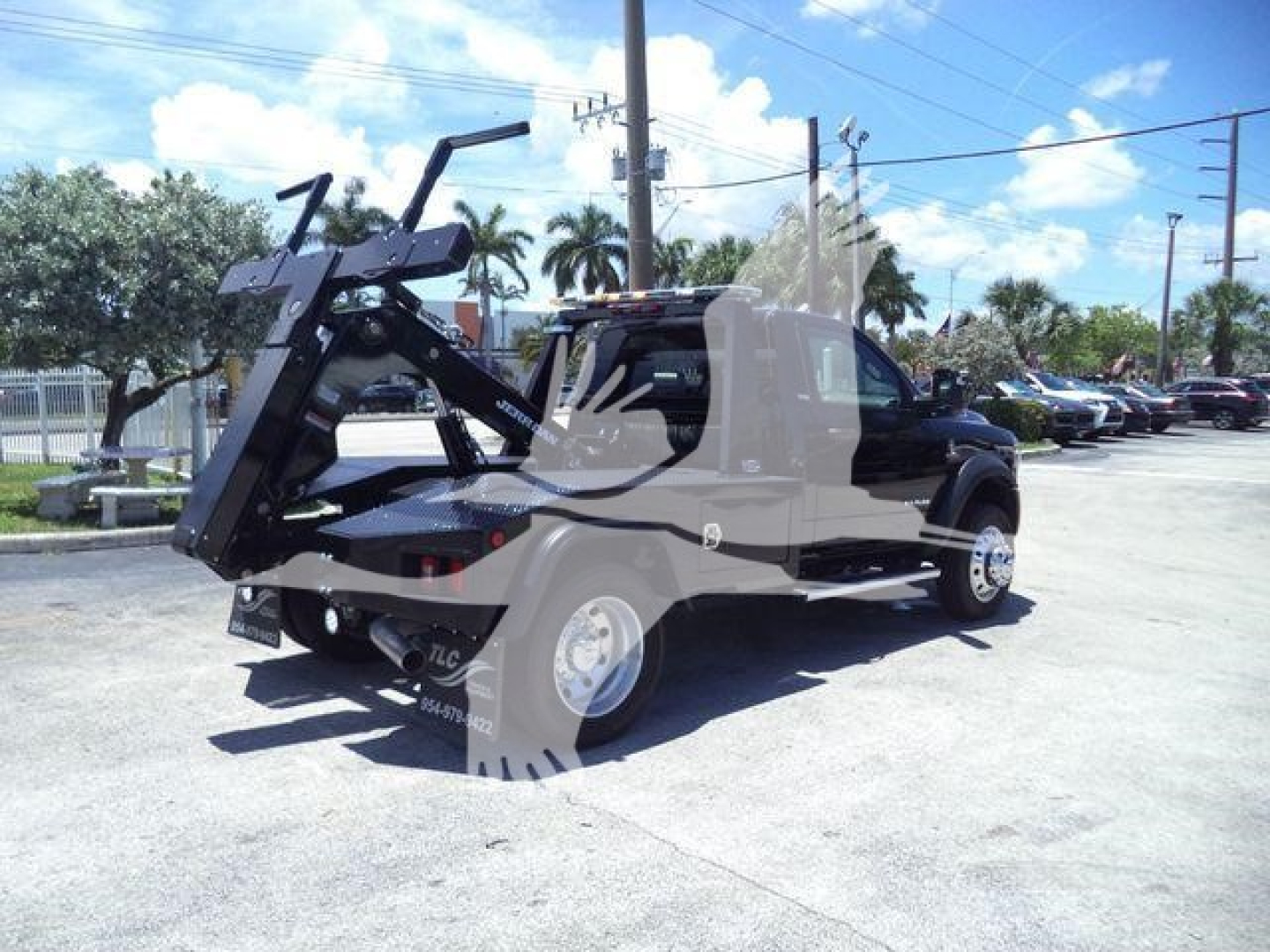 Ram 4500 SN: J98322FM stock winch truck, black, extended cab, front mount winch and crane accessory, visible wheels and bed, dealership lot.