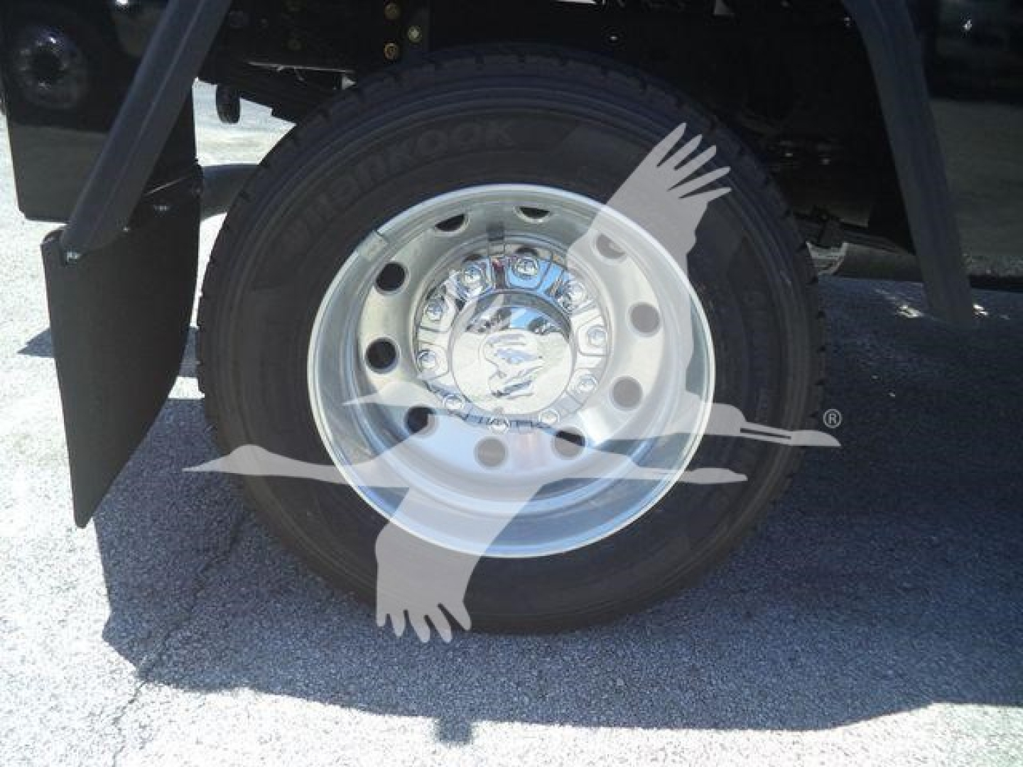 Truck wheel and tire from a 2024 Ram 4500 SLT showing a chrome hubcap and tire branding on the sidewall.