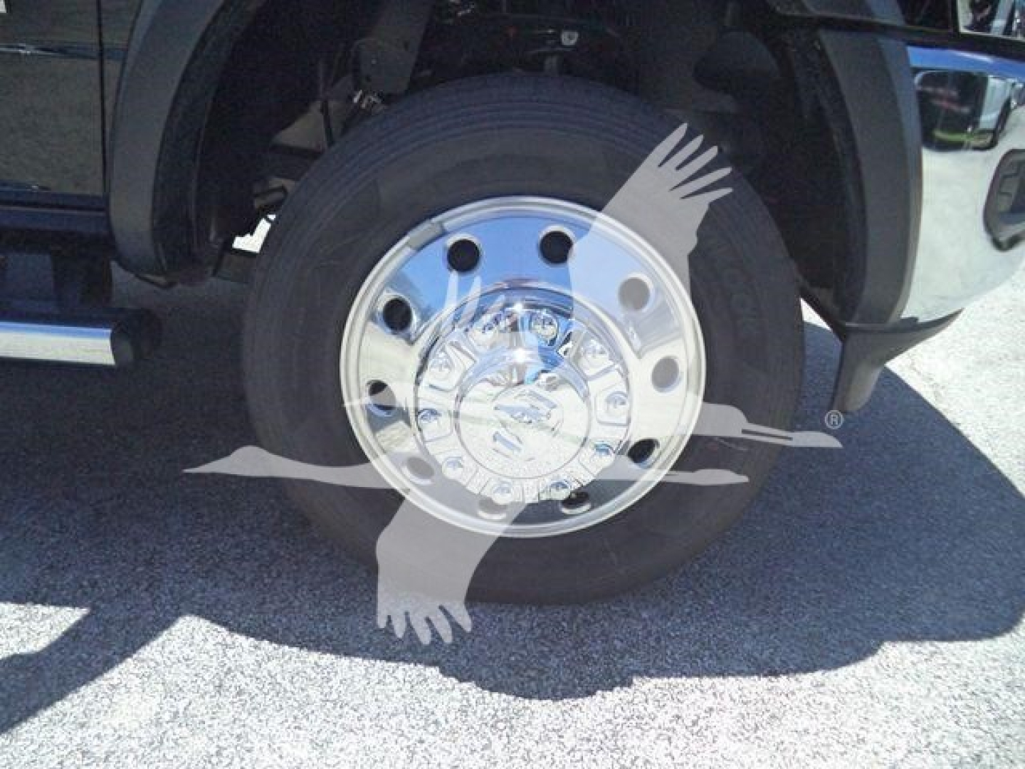 Ram 4500 wheel well and chrome hubcap showing steel rim and tire sidewall; front fender and undercarriage visible.