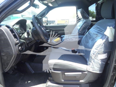 Ram 4500 SLT interior view showing driver and passenger seats wrapped in plastic, front cabin with steering wheel and dashboard visible.