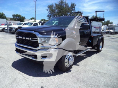 Ram 4500 SLT truck with heavy-duty tow bed and front grille, stock number J98322FM, new unit in a dealership lot.