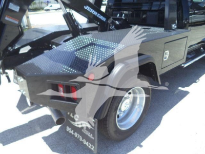 Truck bed with winch equipment and storage compartments on a 2024 Ram 4500 SLT. Visible labels include Jerr-Dan winch arm and tool chest, dual rear tires, metal diamond plate surface.
