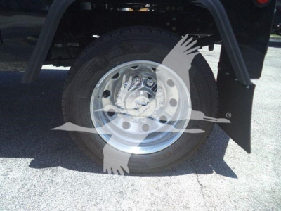 Wheel and tire of a Ram 4500 truck showing steel rim and tire tread with fender and mud flap visible.
