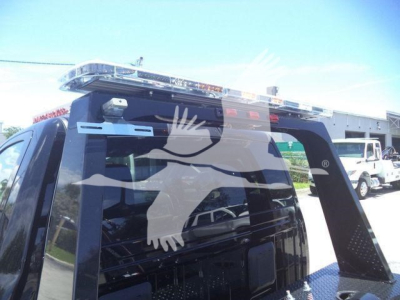 Ram 4500 truck rear window with light bar and winch equipment visible in cargo area.