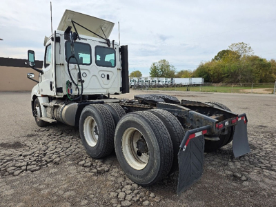 Truck chassis and cab of a 2020 Freightliner Cascadia126 daycab seen from rear-left, showing dual rear axles and mud flaps.