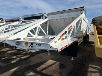 Dump trailer showing Versa Ranco brand white steel框 framed dump structure with triangular lattice side panels and rear hitch, Versa branding visible.