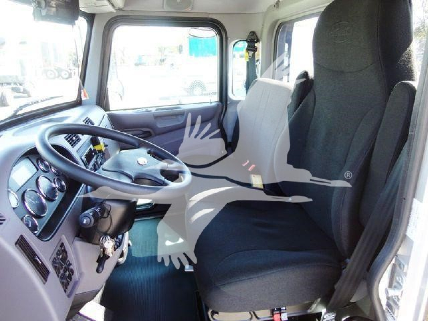 Cab interior of a 2022 Peterbilt 337 truck showing steering wheel, dashboard with gauges, driver and passenger seats.