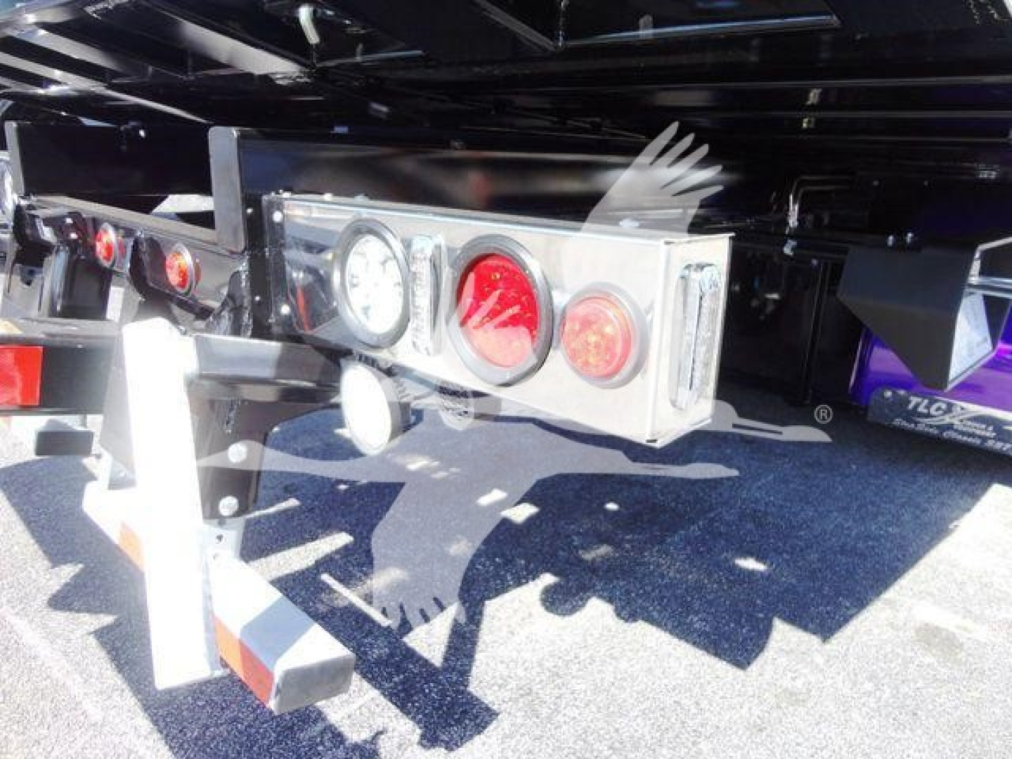 Rear view of a 2022 Peterbilt 337 rollback truck showing trailer hitch and taillight assembly.