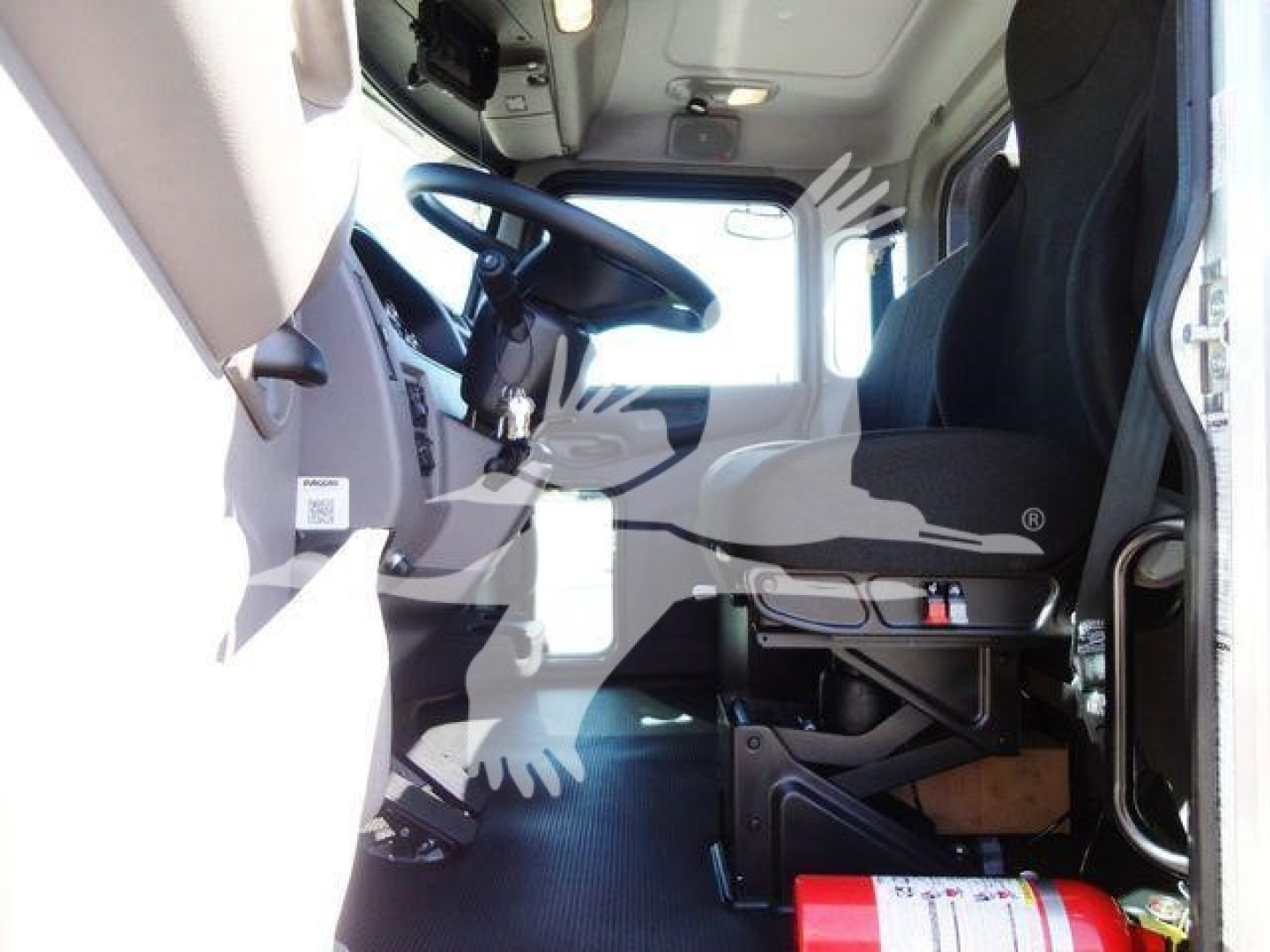 Peterbilt 337 cab interior showing driver seat and dashboard from open door.