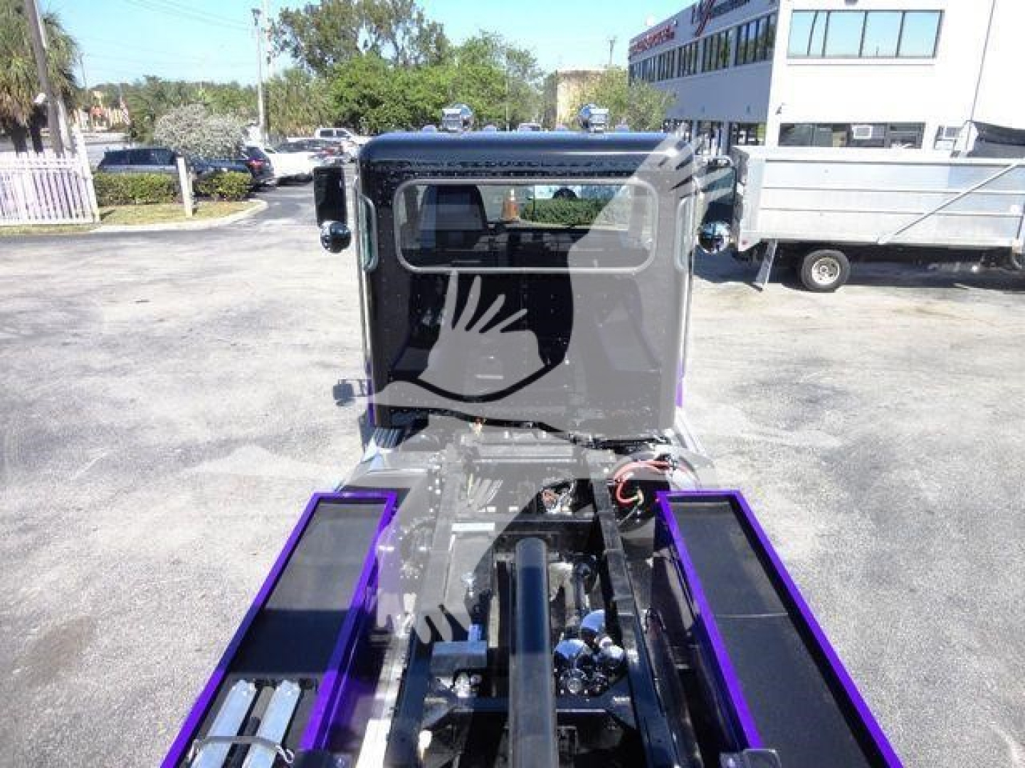 Peterbilt 337 rollback truck cab front view with purple wheel wells and chrome accents, stock J62703.