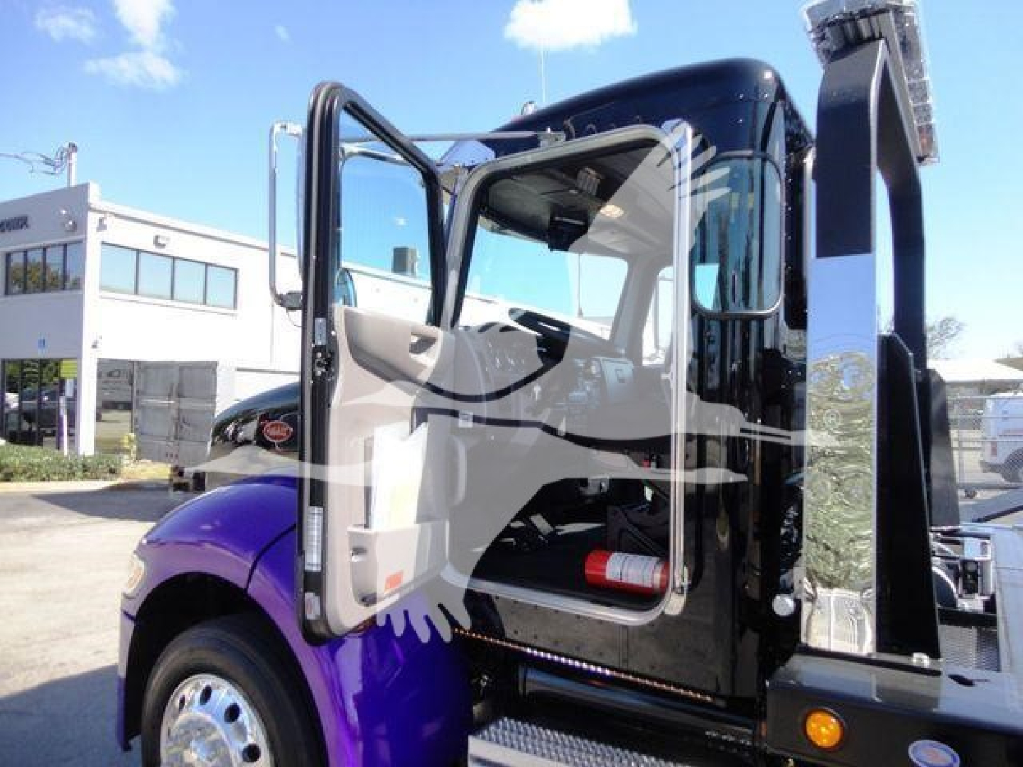 Peterbilt 337 rollback truck cab door open showing interior and steps.