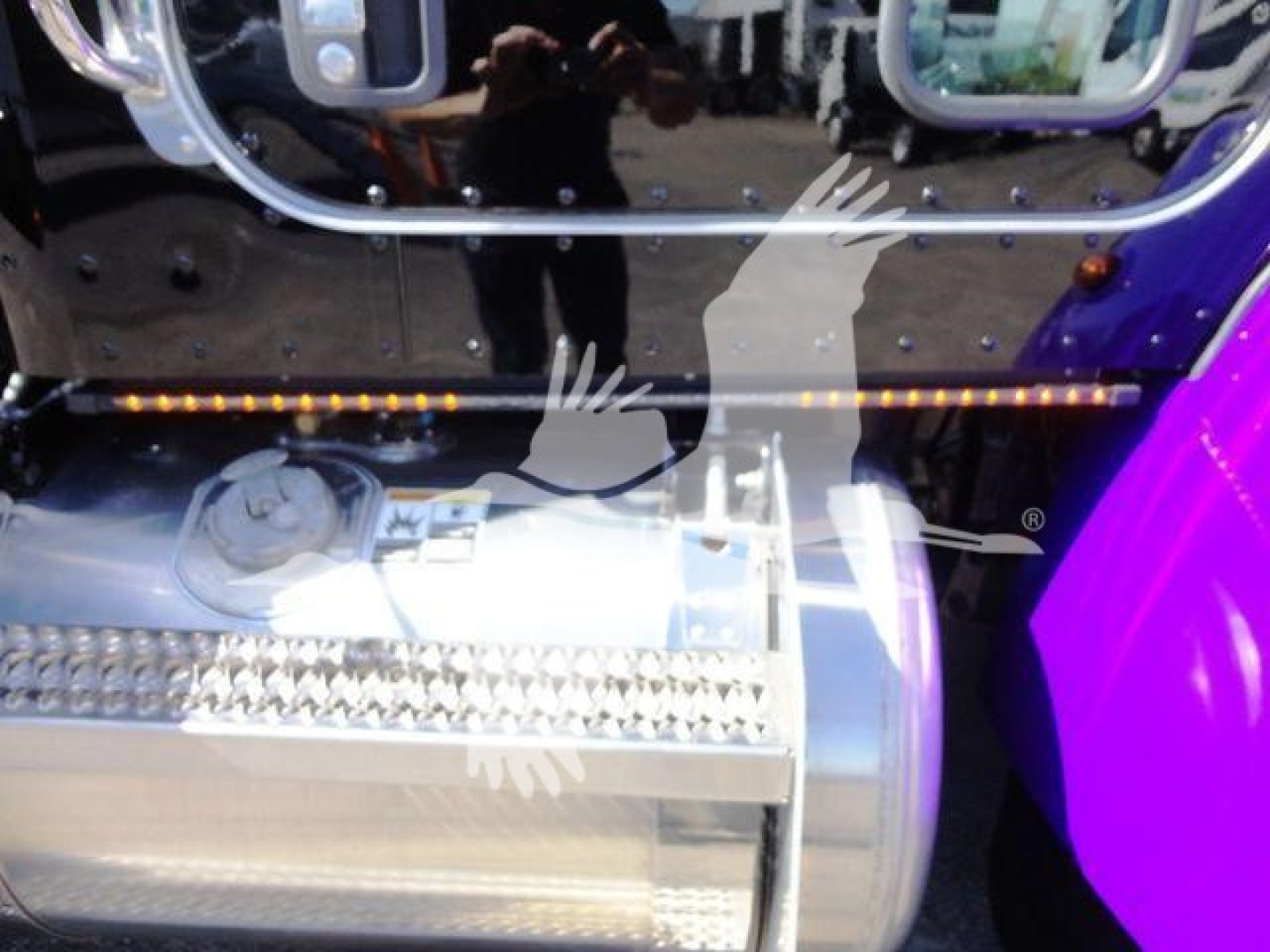 Peterbilt 337 rollback truck fuel tank area showing chrome exhaust/saddle fuel tank and steps.