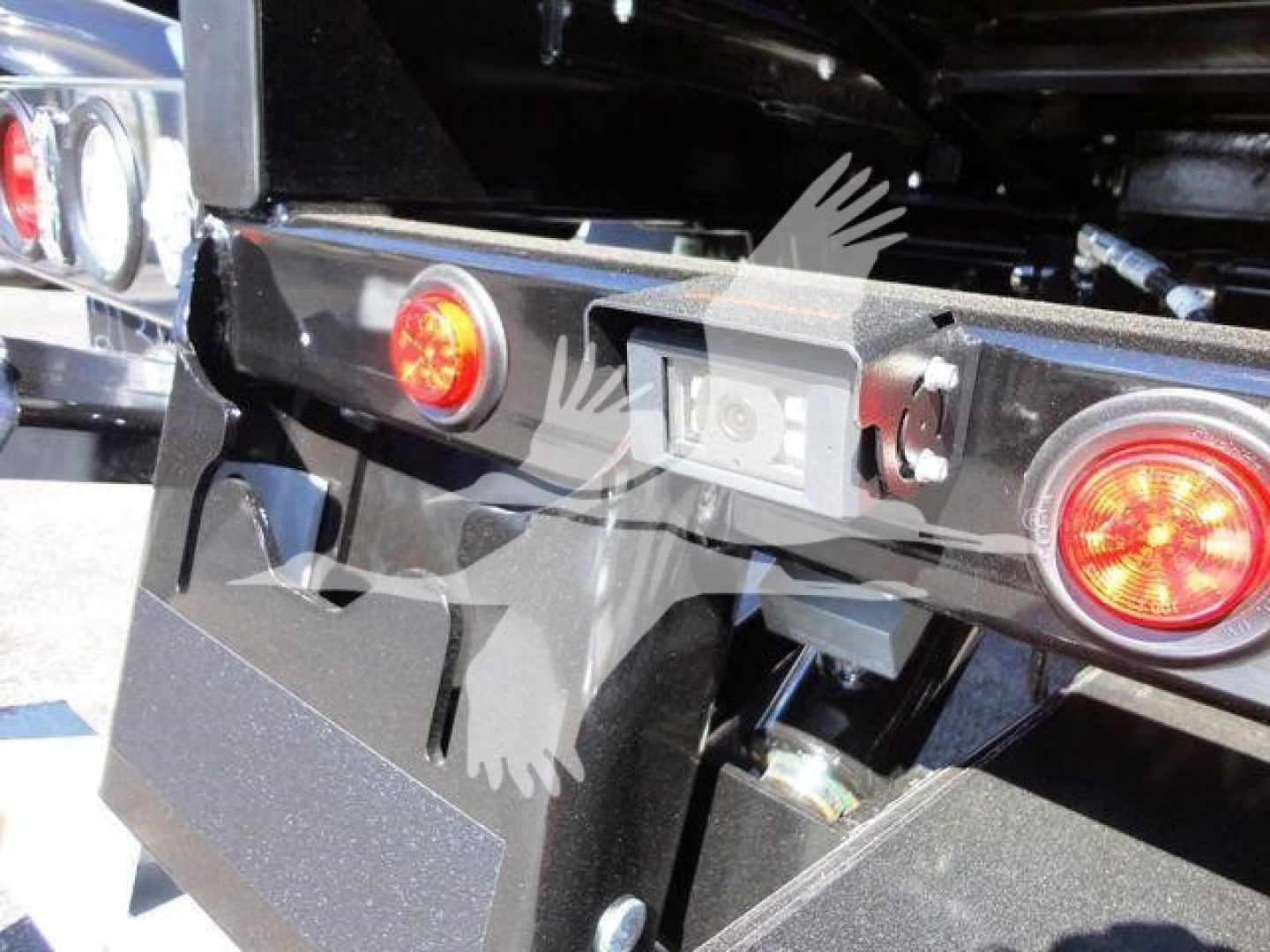 Peterbilt 337 rollback hitch area showing rear lights and license plate area with wiring harness and frame components