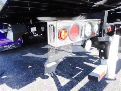 Back of 2022 Peterbilt 337 rollback truck showing rear lights and bumper with license-like plate and hitch; wheel and undercarriage visible.