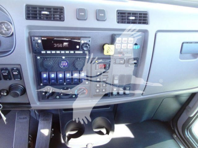 Peterbilt 337 dash area showing radio, climate controls, and dashboard switches with cup holders in the lower center.