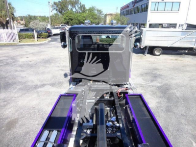 Peterbilt 337 rollback truck cab front view with purple wheel wells and chrome accents, stock J62703.