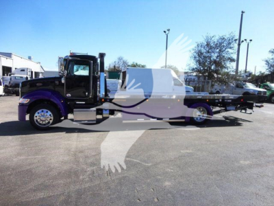 Peterbilt 337 rollback truck side view showing purple cab and long tow bed with chrome wheels and black chassis.