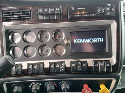 Kenworth truck dashboard with multiple gauges and Kenworth logo display
