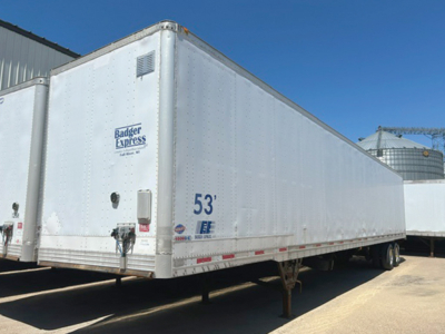 Trailer side view showing 53' Badger Express logo and wheel area in a yard.