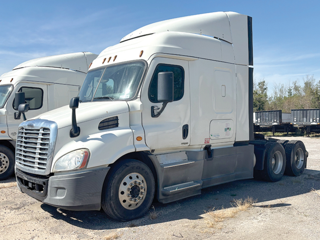 Truck cab view of a 2017 Freightliner Cascadia113 conventional sleeper tractor showing white exterior, dual rear axles, and side mirrors.