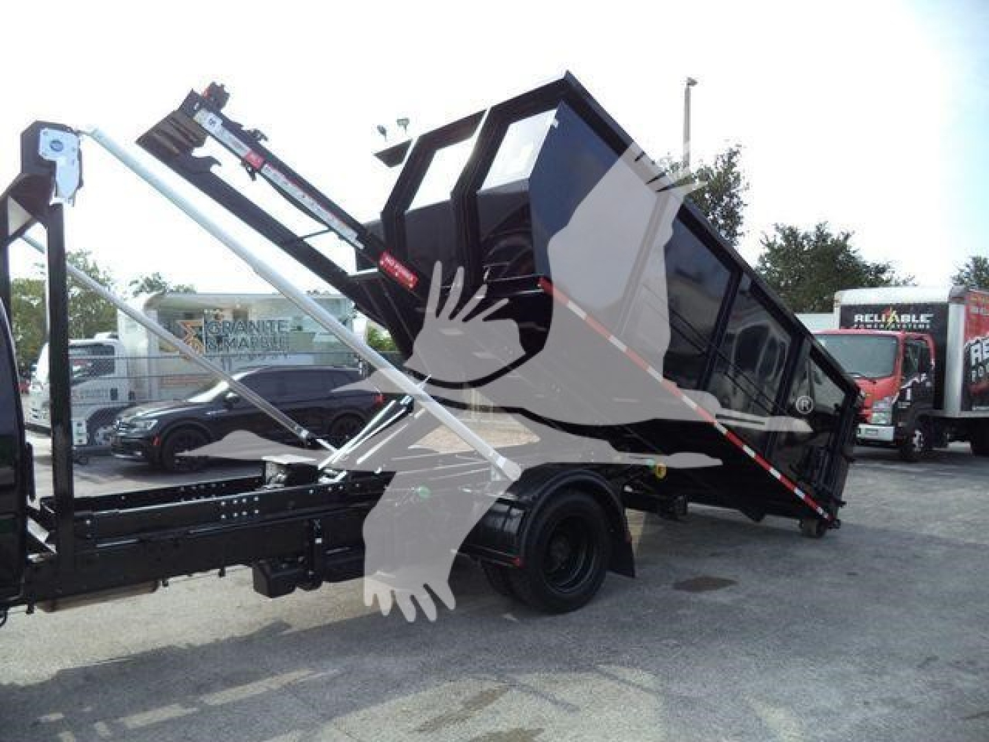 Truck bed tilt/dump truck in raised position with hydraulic arm and black dump body, chevrolet likely context but no legible text visible