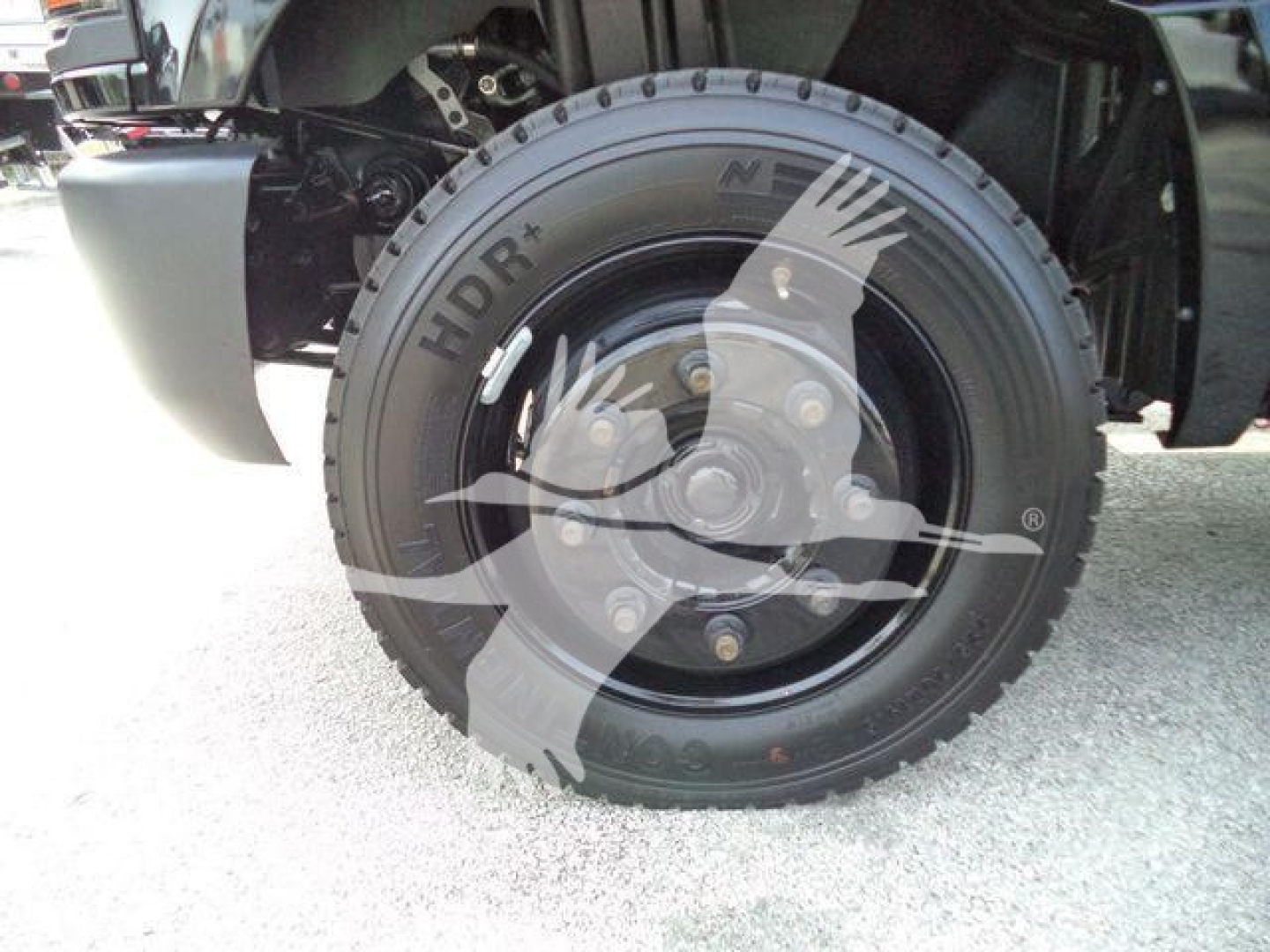 Wheel and tire of a 2023 Chevrolet Silverado 6500HD rollout truck showing HDLR tire brand and wheel assembly.