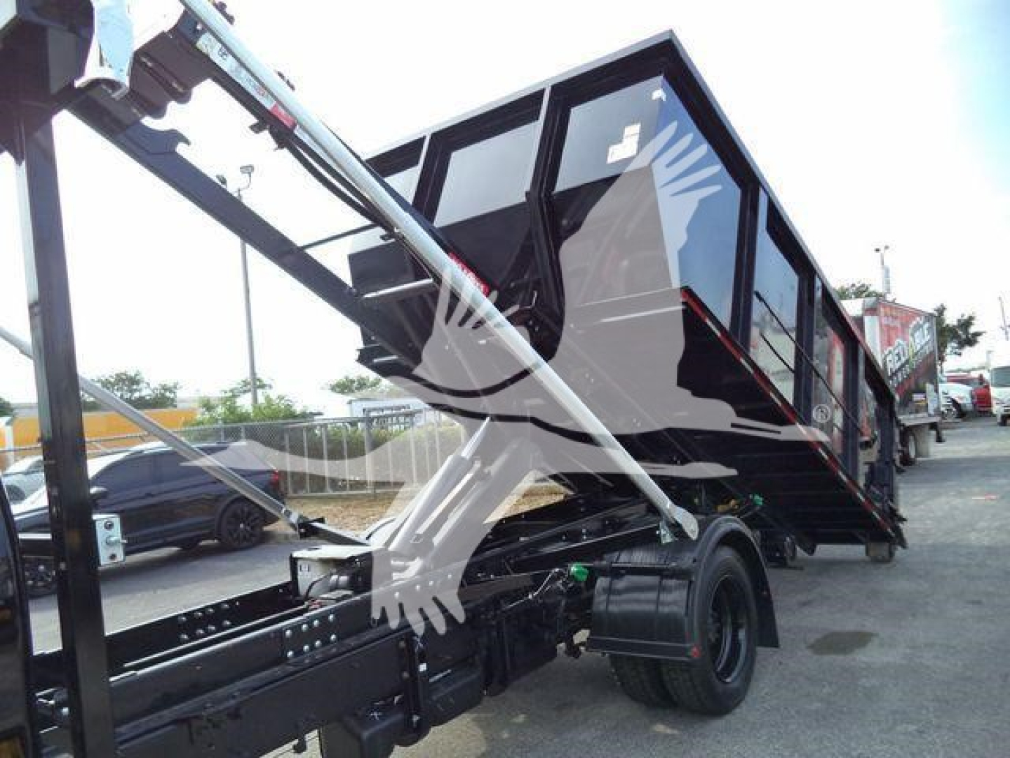 Chevrolet Silverado 6500HD rollover truck cargo bed and hydraulic lift in-view showing side profile and truck chassis.