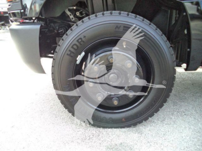 Wheel and tire of a 2023 Chevrolet Silverado 6500HD rollout truck showing HDLR tire brand and wheel assembly.
