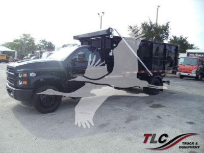 Chevrolet Silverado 6500HD dump truck in a lot, black body, roll-off bed, front grille, side mirrors, and wheel bolts visible.