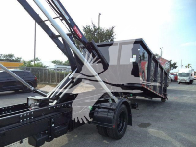 Truck chassis and roll-off bed showing hydraulic arms and cab in a new Chevrolet Silverado 6500HD roll-off truck.