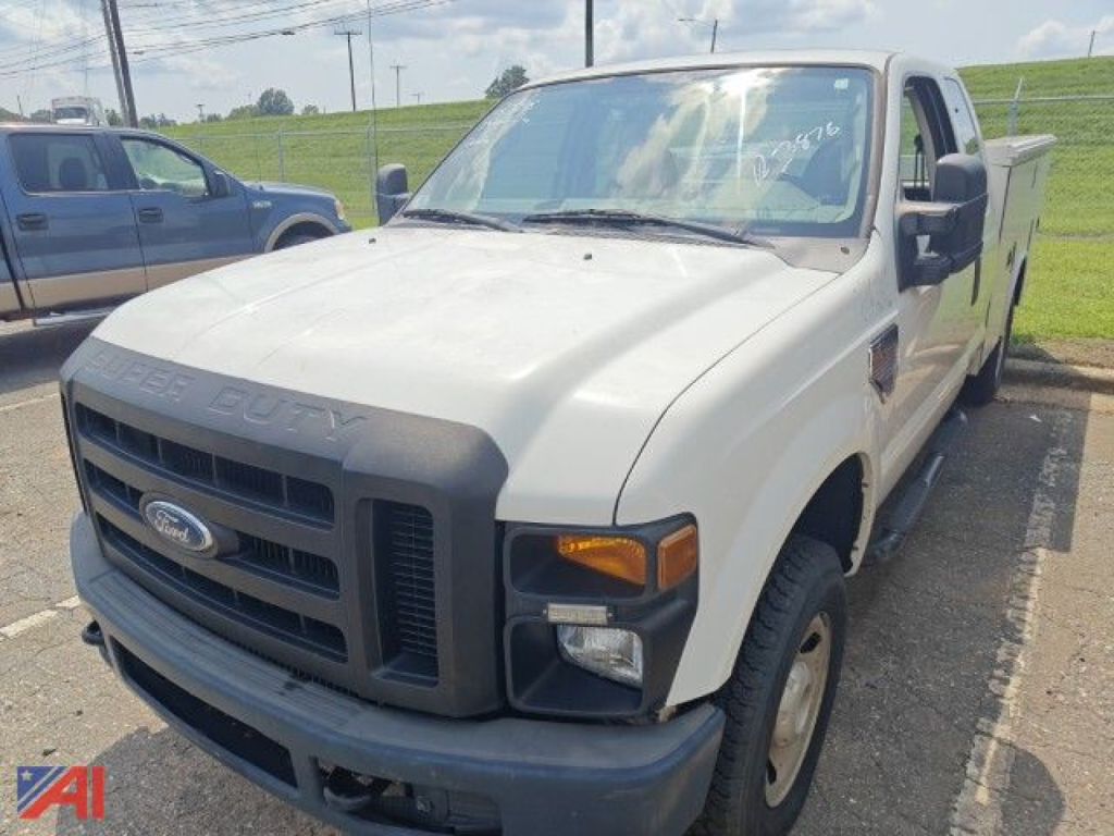 Ford F-250 Super Duty service truck front-left view showing cab, grille, headlights, and utility bed in a parking lot.