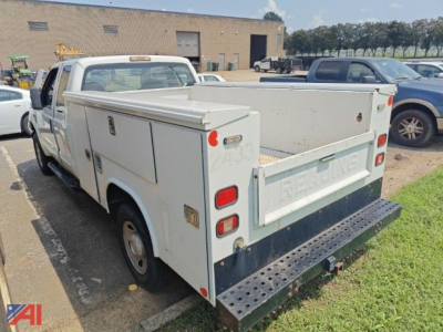 White 2009 Ford F-250 Super Duty service/utilities truck with utility bed, side compartments, and a stepped heavy-duty rear bumper. READ: 'RELIABLE' embossed on tailgate.