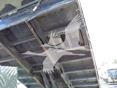 Ford E450 dump truck bed underside showing steel framework and underside of bed with hoist area.