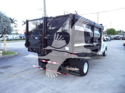 Ford E-450 dumping truck rear view showing dump bed and dual rear tires with stock number T20696.