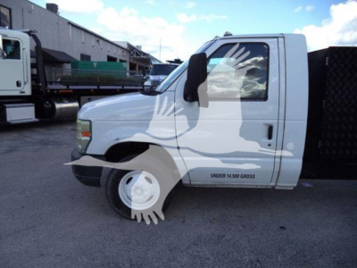 Truck cab side view showing Ford E-450 utility/ dump truck with white paint, under 14500 gross, side text details faint, VIN visible in listing metadata.
