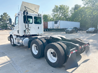 Freightliner Cascadia 126 tractor rear view showing dual rear axles, fifth wheel, and mud flaps.