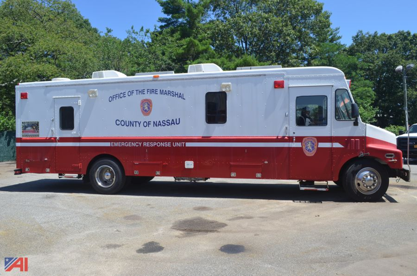 Fire department vehicle: 1990 Chevrolet P60 forward control chassis command truck viewed in side profile with Nassau County Office of the Fire Marshal markings.