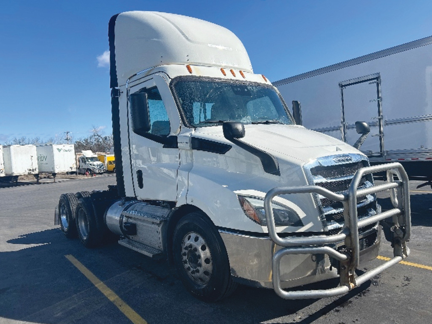 Freightliner Cascadia116 tractor in white, front view with bull guard and aerodynamic sleeper cab.