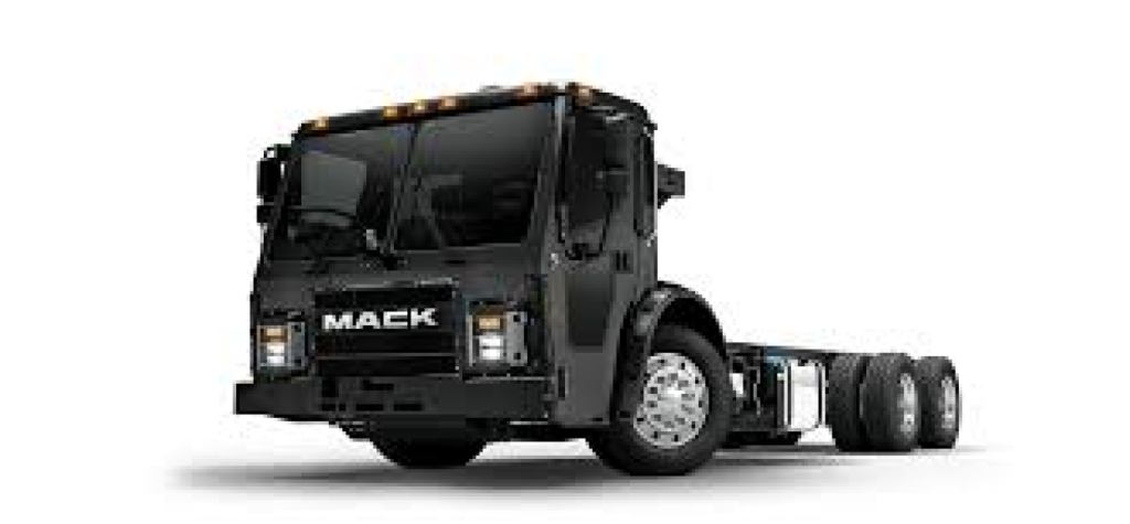 Mack LR64 cab and chassis truck front-left view with black paint and illuminated clearance lights.