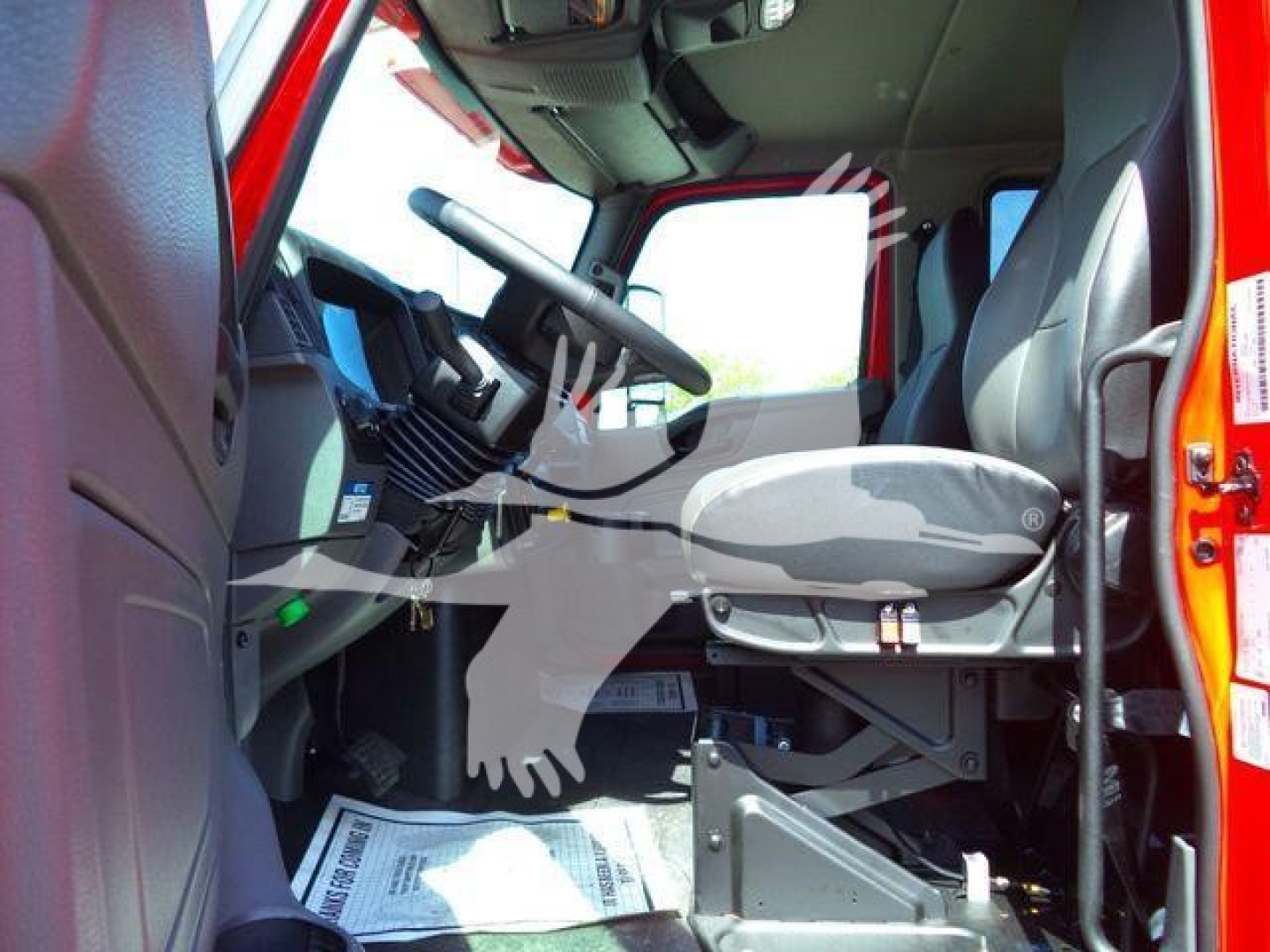 Truck cab interior showing steering wheel and driver's seat in a new 2027 International MV rollback truck.