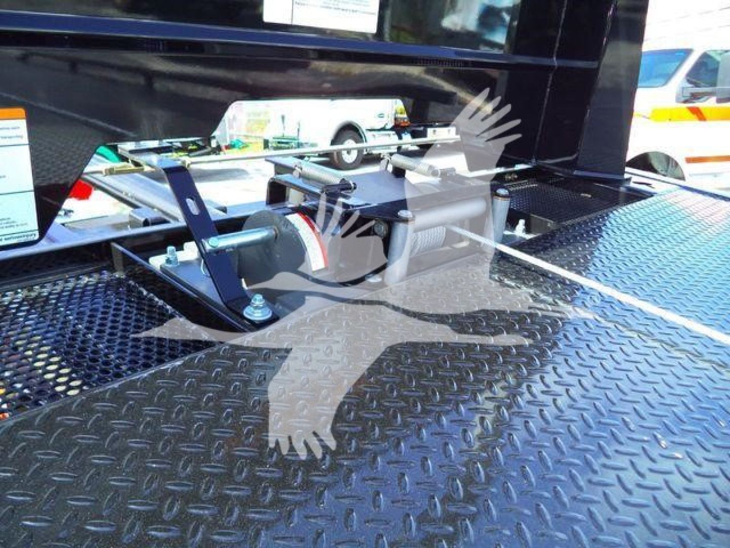 Trucks equipment platform with winch mount and heavy-duty diamond plate surface for rollback trucks showing mounting hardware and clamps.