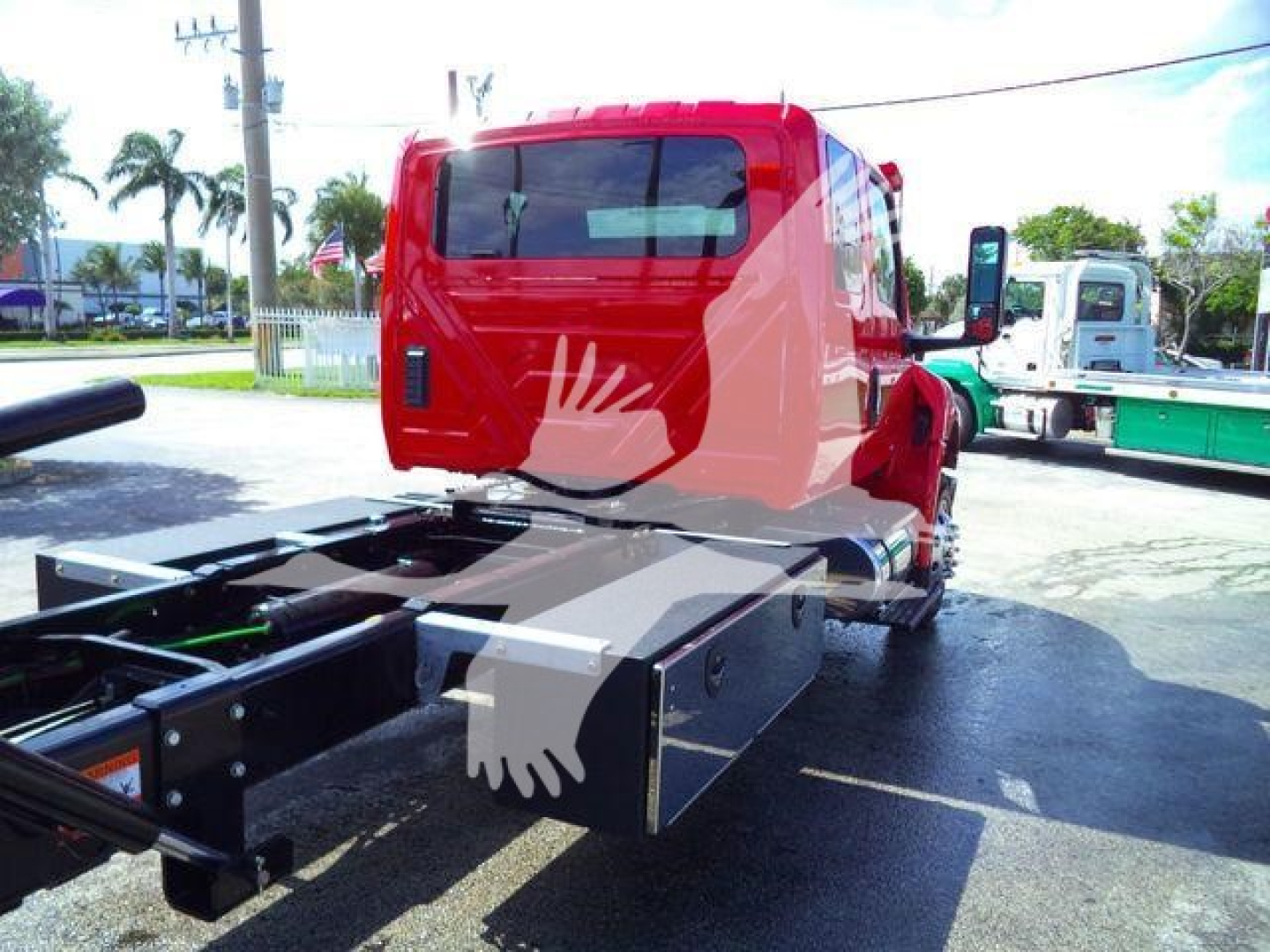 Truck cab rear and chassis with flatbed/boom rollback component visible, MV607RED stock number, red International MV truck