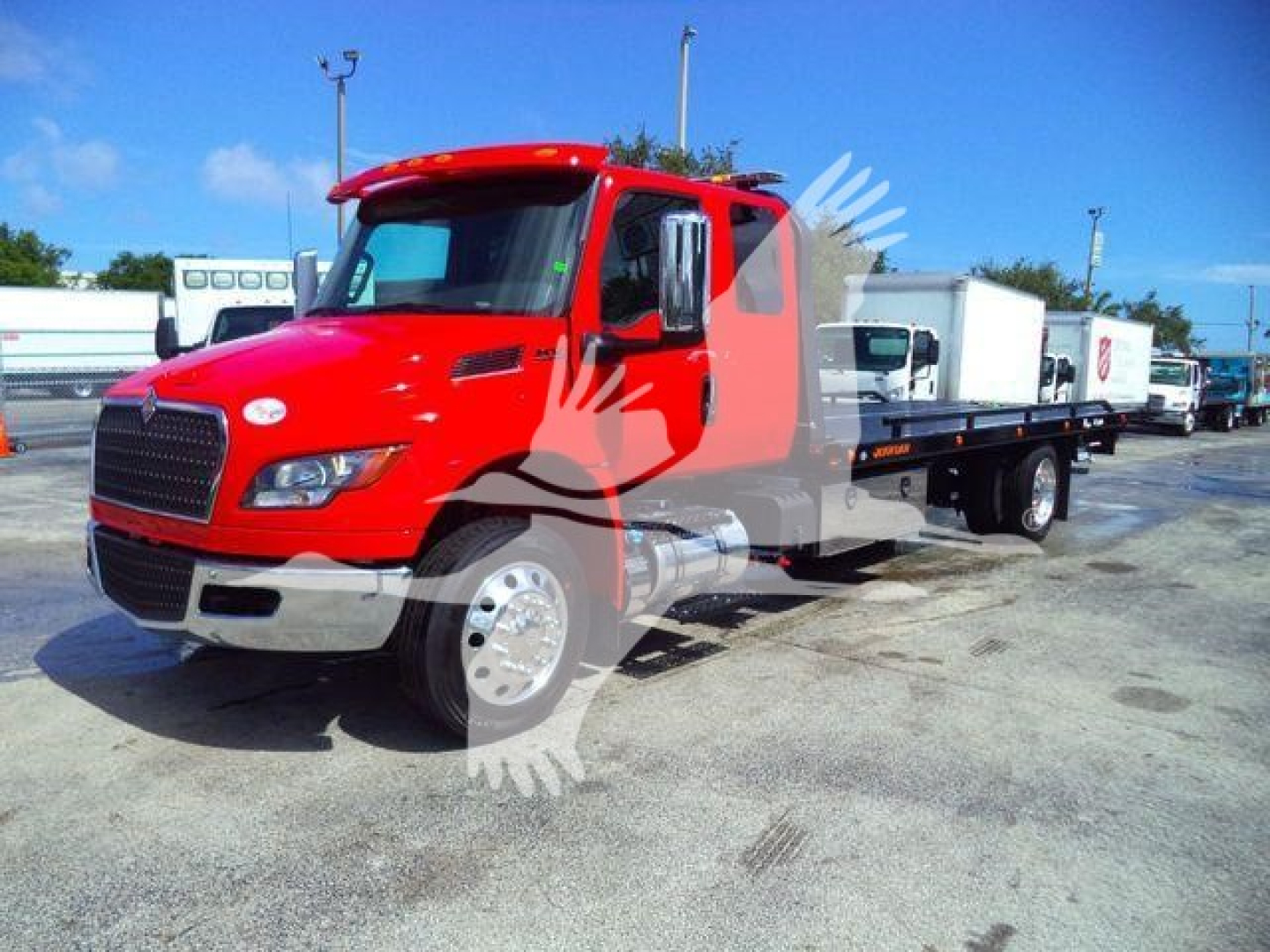 Red 2027 International MV rollback truck shown, side view with flatbed/recovery equipment and stock number MV607RED.