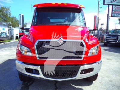 Front view of red 2027 International MV rollback truck showing bold grille, chrome bumper, and large headlights.