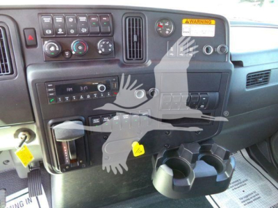 Dashboard view of a 2027 International MV truck showing control panel, gauges, cup holders, and various switches.